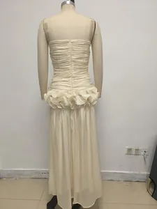Rear view of cream strapless evening gown with pleated bodice and ruffled waist detail