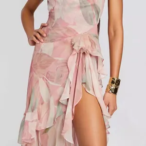 Detailed view of pink floral print dress featuring a side slit and ruffles.