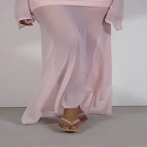 Detail of fairy pink mesh dress showing flowing irregular hemline and sheer fabric