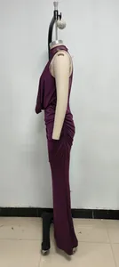 Side view of a plum purple ruched evening gown with halter lace neckline.