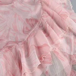 Close-up detail of pink floral print dress showing elegant ruffle texture and stitching
