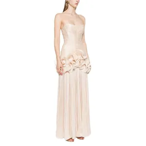 Elegant champagne strapless dinner gown featuring pleated ruffles and a long flowing skirt