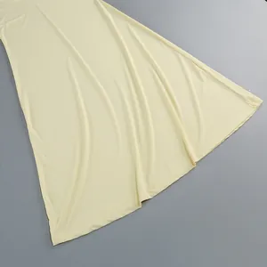 Primer plano del tejido suave y el dobladillo de un vestido largo amarillo pálido de estilo francés