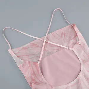 Close-up detail of backless pink floral summer dress with adjustable criss-cross straps.