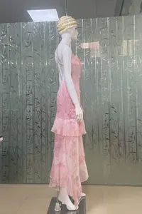 Detailed side view of a pink floral backless dress with ruffles and asymmetric hem.