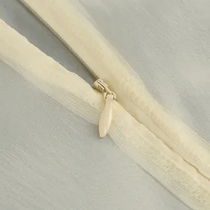 Detalle de cremallera invisible de lágrima en un vestido de tul de estilo francés.
