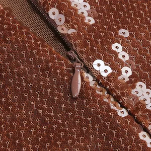 Nahaufnahme des versteckten Reißverschlusses an einem dunkelbraunen Paillettenkleid.