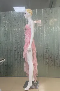 Detailed side view of pink ruffled floral dress with sexy high slit on mannequin