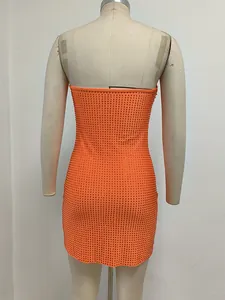 Vista posterior de un minivestido ajustado naranja con strass sobre un maniquí