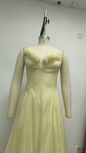 Detalle del vestido de hada amarillo de estilo francés con volantes y escote con cordones