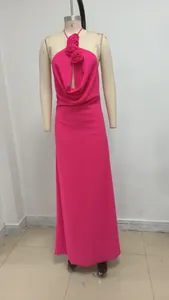 Vista detallada de un vestido de noche fucsia con cuello halter y flores de tela hechas