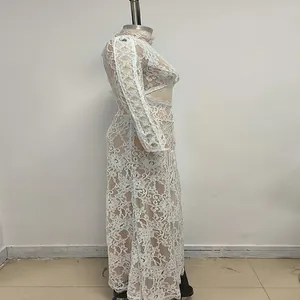 Side view of white lace floor-length dress with long sleeves and hollow-out waist