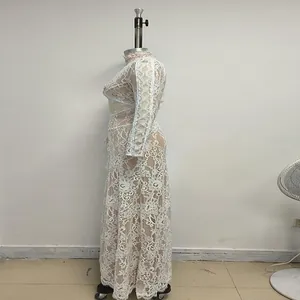 Detailed side view of white lace long sleeve see-through maxi dress on mannequin stand.