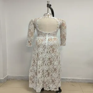 Detailed rear view of white lace maxi dress featuring an open back on a mannequin.