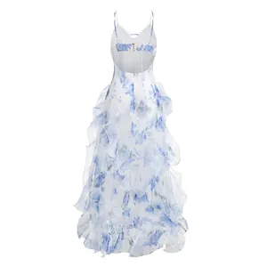 Back view of a white French maxi dress with blue floral print and ruffled layers.