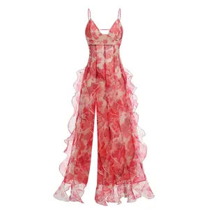 Detailed view of red floral camisole dress with elegant ruffle layering and low neckline