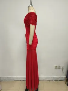 Vista laterale di un elegante abito lungo rosso con spalle scoperte in rete e tulle.