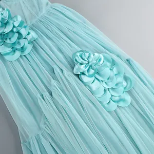 Macro detail of a light blue pleated mesh dress featuring exquisite satin flower appliques