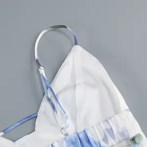 Close-up of adjustable spaghetti strap on a white floral print summer midi dress