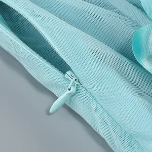 Macro view of light blue mesh fabric featuring a high-quality concealed zipper.