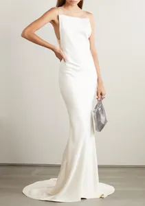 Elegant white backless evening gown with a slim fishtail silhouette and long train.
