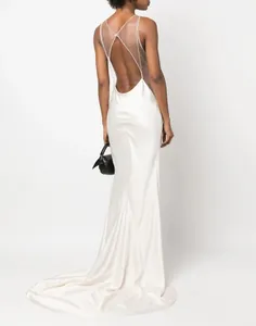 Elegant back detail of a white backless satin evening gown with a graceful long train