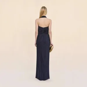 Back view of a pleated navy blue halter neck maxi dress for elegant evening events.