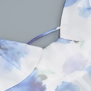 Detailed close-up of blue floral satin dress neckline and elegant shoulder strap