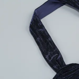 Close-up of pleated deep sea blue metallic fabric strap on an elegant halter evening dress