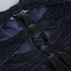 Detailed macro shot of deep sea blue pleated evening gown fabric with silver ring accents