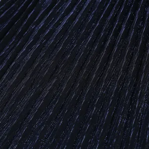 Detailed macro view of dark navy blue pleated shimmering fabric for evening dress