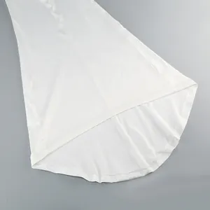 Detailed view showing the elegant high-low hemline and smooth fabric of the white evening gown