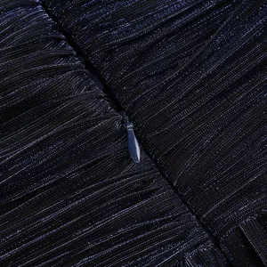 High-quality close-up of the hidden zipper on a navy blue pleated shimmering evening dress