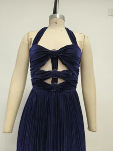 Detailed close-up of navy blue pleated halter evening dress with gold ring cut-outs