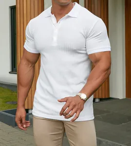 Detail view of a white muscle fit polo shirt with vertical ribbed texture and button collar