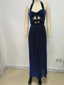 Detail of deep sea blue pleated halter dress with front cut-outs and ring accents.