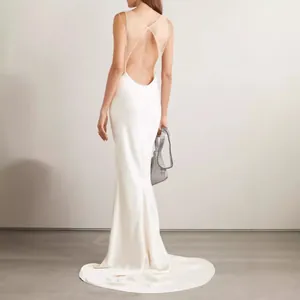 Elegant white backless evening gown featuring a long train and slim-fit silhouette