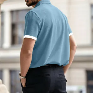 Detailed back view of a men's light blue waffle texture polo shirt with white sleeve cuffs