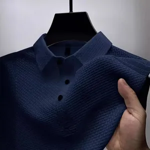 Close-up of navy blue waffle texture fabric on men's quick-dry polo shirt with collar
