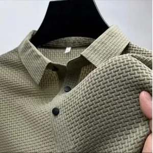 Detailed macro view of khaki textured quick-dry polo shirt showing fabric elasticity