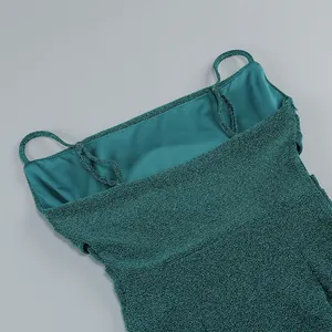 Détail rapproché d'une robe verte scintillante à bretelles montrant la texture et la doublure
