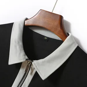 Dettaglio polo uomo con colletto a contrasto grigio e cerniera lampo metallica