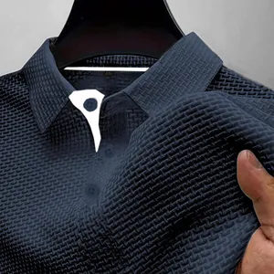 Close-up of breathable ice silk textured fabric on navy blue men's polo shirt.