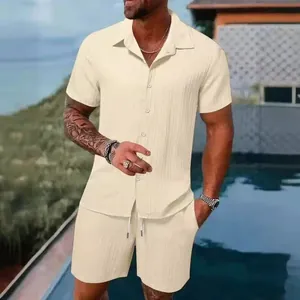 Lifestyle shot of a men's beige two-piece outfit with textured fabric in a summer setting