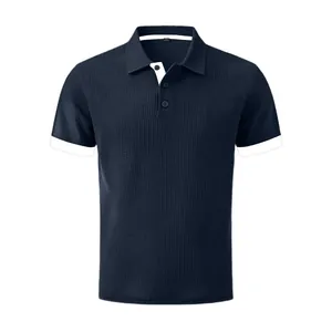 Detailed view of navy blue waffle knit men's polo shirt with contrast white collar trim