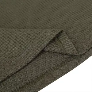 Close-up detail of olive green waffle knit fabric showing premium stitching and hem
