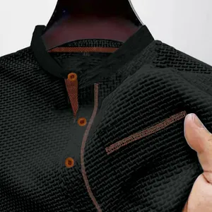Close-up of black breathable ice silk men's polo shirt showing honeycomb fabric texture