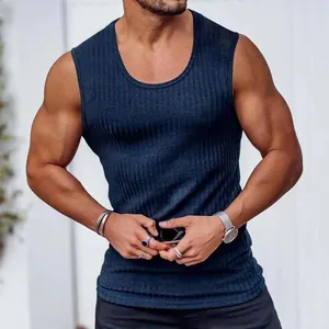 Close-up of men's navy blue ribbed slim-fit sports gym tank top showing texture and fit.