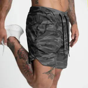 Detailed view of men's grey camouflage quick-dry sports shorts for fitness and gym.