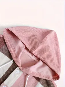 Close-up of the ribbed fabric hood and plaid design on a heavy men's shirt detail